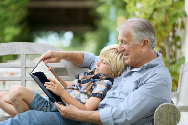 Men's health month - grandfather reading to grandson